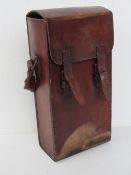 A leather Huntsman type bag having short strap and double buckles to front.