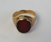 A 9ct gold and carnelian signet ring, stamped 9ct, size J-K, 3.8g.