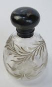 A hallmarked silver and cut glass perfume bottle, HM for London and having floral pattern upon.