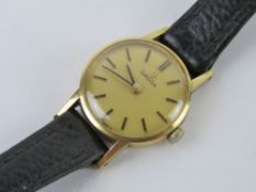 A 9ct gold ladies Omega wristwatch having champagne dial marked for Omega, crown wheel, strap,