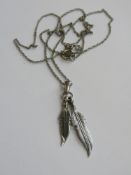 A Native American style two feather pendant in 925 silver on a 925 silver chain.