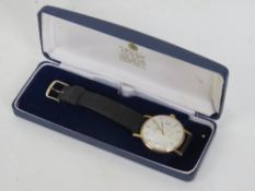 A 9ct gold Garrard Automatic wrist watch in original presentation box and on original Garrard strap,