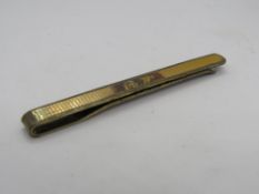 A 9ct gold on silver tie clip, engraved RW.