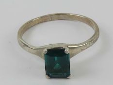 A silver ring having central rectangular cut rich green stone, stamped 925, size S.