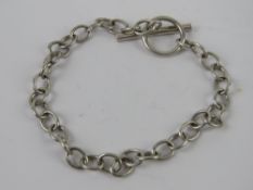 A hallmarked silver charm bracelet having T-bar clasp, hallmarked 925 and measuring 18cm in length,