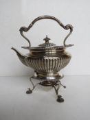 A delightful hallmarked silver teapot complete with stand and spirit burner,