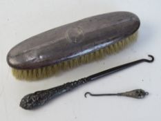 A hallmarked silver button hook having shamrock design upon,