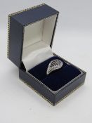 A silver cocktail ring encrusted with white and black cz stones, stamped 925, size S.