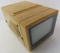 A mini black and white television. No cable.