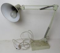 A white painted metal angle poise style table lamp.
