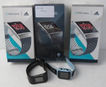 A quantity of Fitbit and other watches, one noted as faulty.