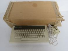 An Acorn Electron computer keyboard in original packaging.