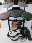 A Wii Rockband being drumset, guitar, base, etc, inc three Guitar Hero games.