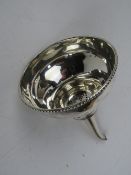 A silver plated wine pourer.