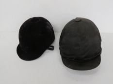 Two horse riding helmets for decorative purposes only. The larger being size 6 7/8 - 7.