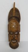 A hand carved tribal wall mask approx 57cm in length.