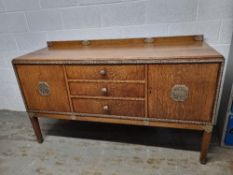 A delightful early 20th century oak dresser having silver painted floral carving throughout,