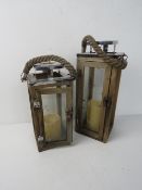 A graduated pair of wooden garden lanterns, rope handles approx. 35 and 28cm high respectively.
