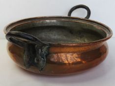 A copper balti dish having iron end handles, 49cm wide overall.
