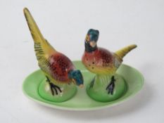 A Carltonware cruet in the form of pheasants being salt and pepper with tray under.