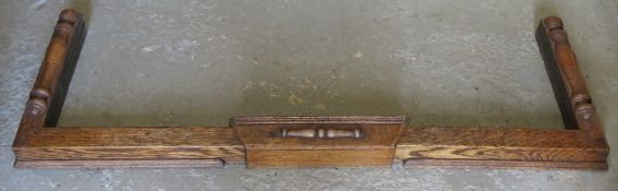 A oak and brass fireside fender, internal width 106.5-133cm.