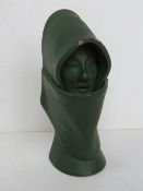A green painted terracotta sculpture of a hooded female. 17.5cm high.
