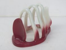 A Carltonware Australian design toast rack in pink.