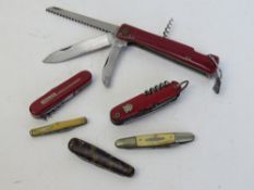 Three Swiss Army type knives and three pocket knives. Six items.