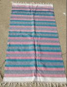 A contemporary cotton 'garden rug' in pink and turquoise, measuring approx 257 x 84cm.