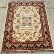 A cream ground 100% hand spun Afghan woollen rug, bearing label verso,