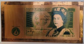 A large solid copper Bank of England 'One Pound Note' measuring approx 90 x 45cm.