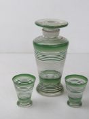 An Art Deco decanter with matching pair of tot cups, decanter standing 22.5cm high.