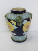 A large part glazed Majolica vase having sunflower design with relief vine design and dragons head