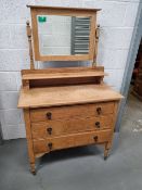 A stripped pine dressing table having three drawers and rectangular mirror over,