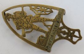 A brass iron trivet 'A gentleman in Khaki' approx 16.5cm in length.