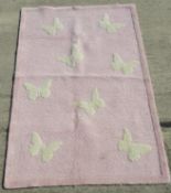 A 100% woollen hand tufted rug bearing label to back,