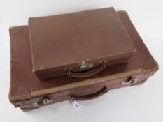 A vintage pigskin and cardboard suitcase together with small cardboard case having pigskin handle.