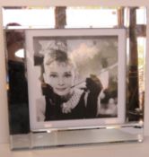 Audrey Hepburn print in mirrored glass frame, overall 54.5 x 54.5cm.