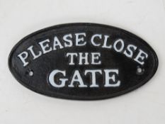 A contemporary cast iron 'Please Close the Gate' sign 17.5cm wide.