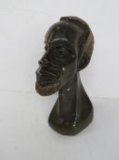 A green stone carving of a male bust, approx 21cm high.