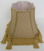 A neutral / cream and sand coloured lampshade with tassel decoration, approx 35cm wide.