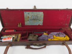 A leather shotgun case bearing label for Henry Clarke Leicester to the red baize lined compartment