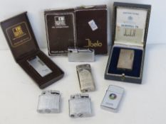 A Dunhill 70 lighter in original box with instructions, together with a quantity of other lighters,