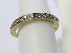 An 18ct and Platinum diamond half eternity ring, the diamonds set in white metal with raised border,