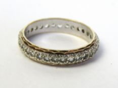A 9ct gold eternity ring, central white gold band with diamond cut yellow gold border, size L, 2.2g.