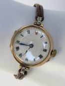 A ladies 9ct rose gold manual wristwatch having white enamel dial with black and red Roman numerals,