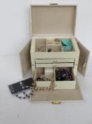 A contemporary white leatherette jewellery box containing a quantity of assorted costume jewellery