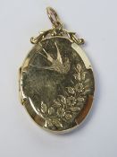 A large vintage locket having Swallow and Forget-me-Not engraved pattern to each side,