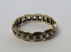 A white stone eternity ring in white and yellow metal, stamped 9, size N, 2g.