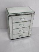 A mirrored glass jewellery box.